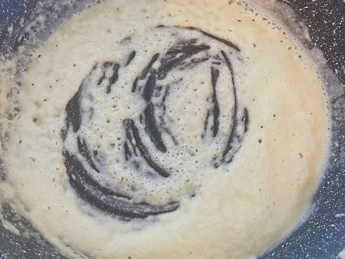 roux being made with flour and butter in frying pan